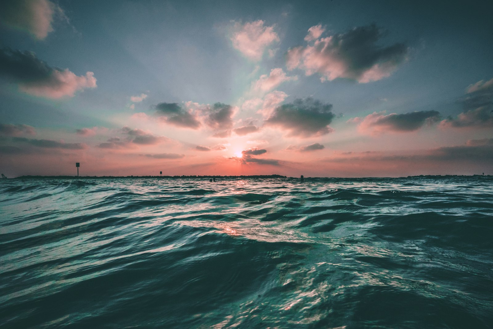 Sunset over dark ocean swell