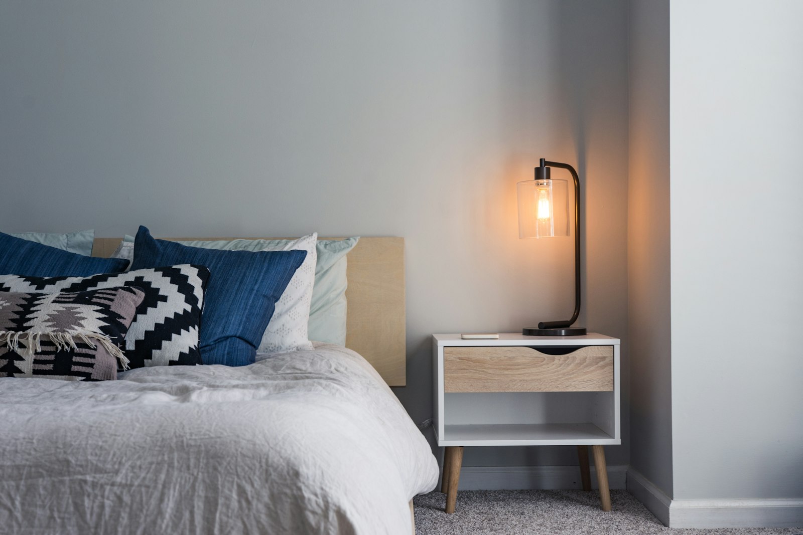 Cozy lodge bedroom with a warm reading lamp
