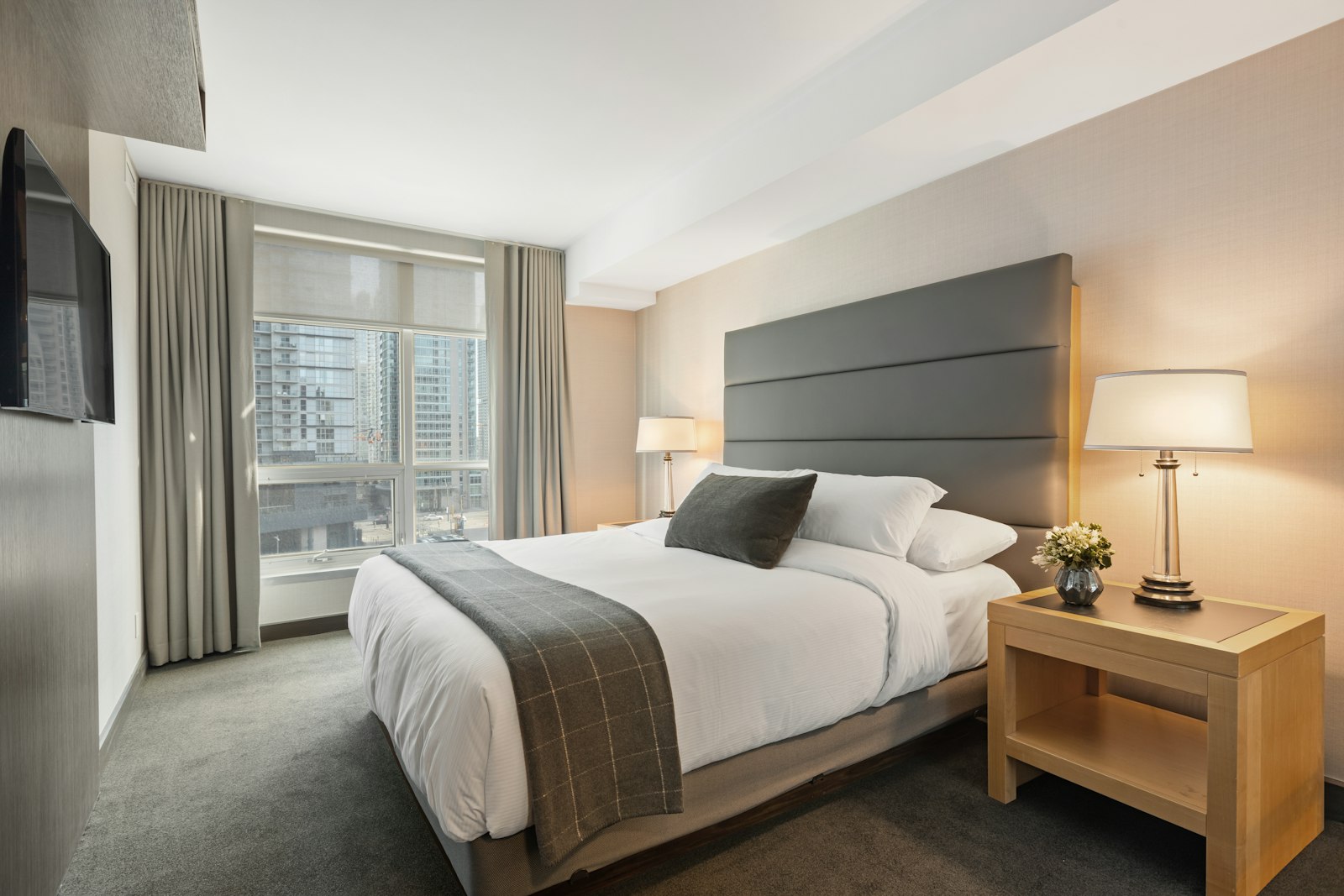 Larger hotel room with queen bed and sitting space