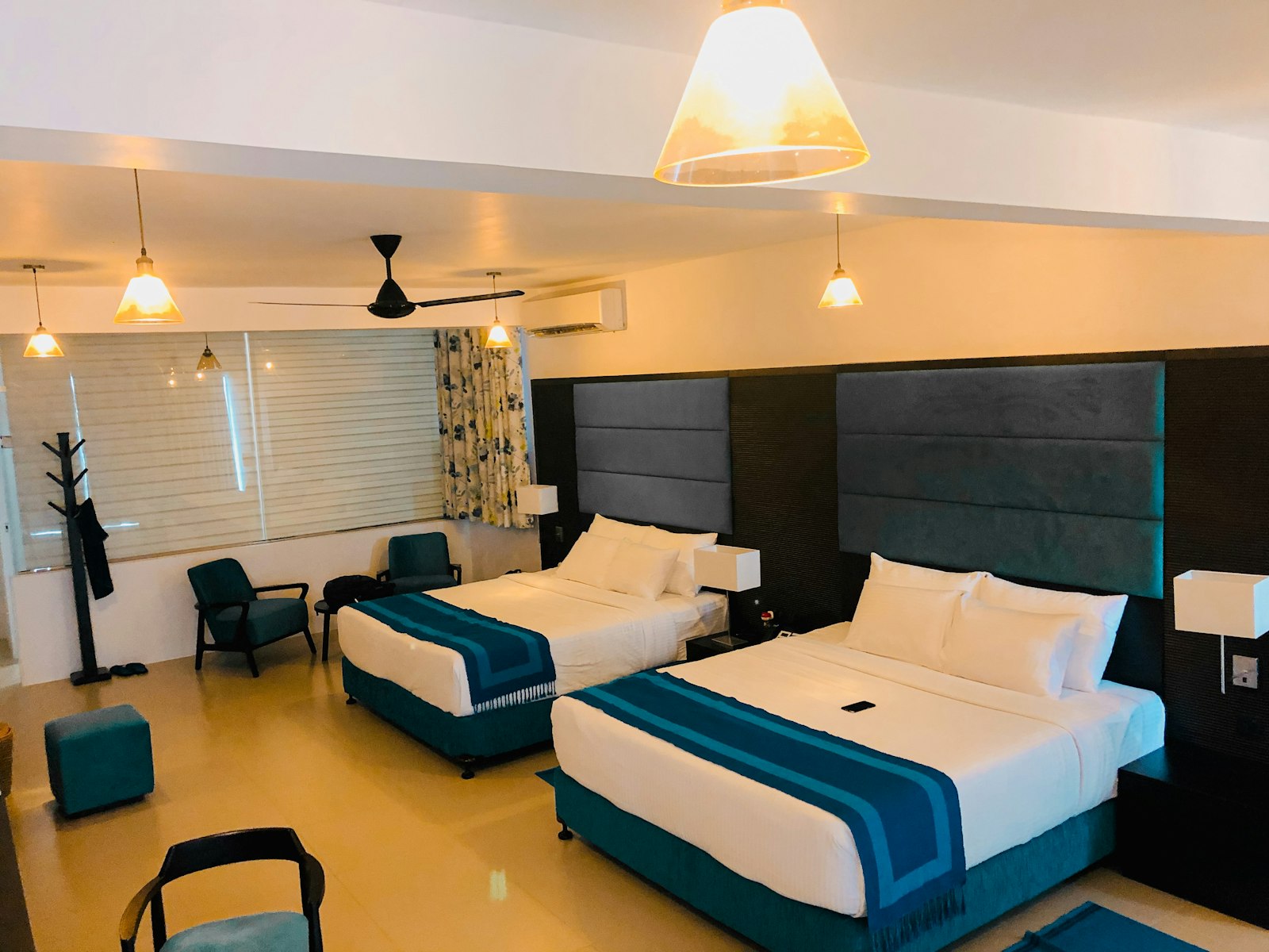 Room with two beds made up with white linens