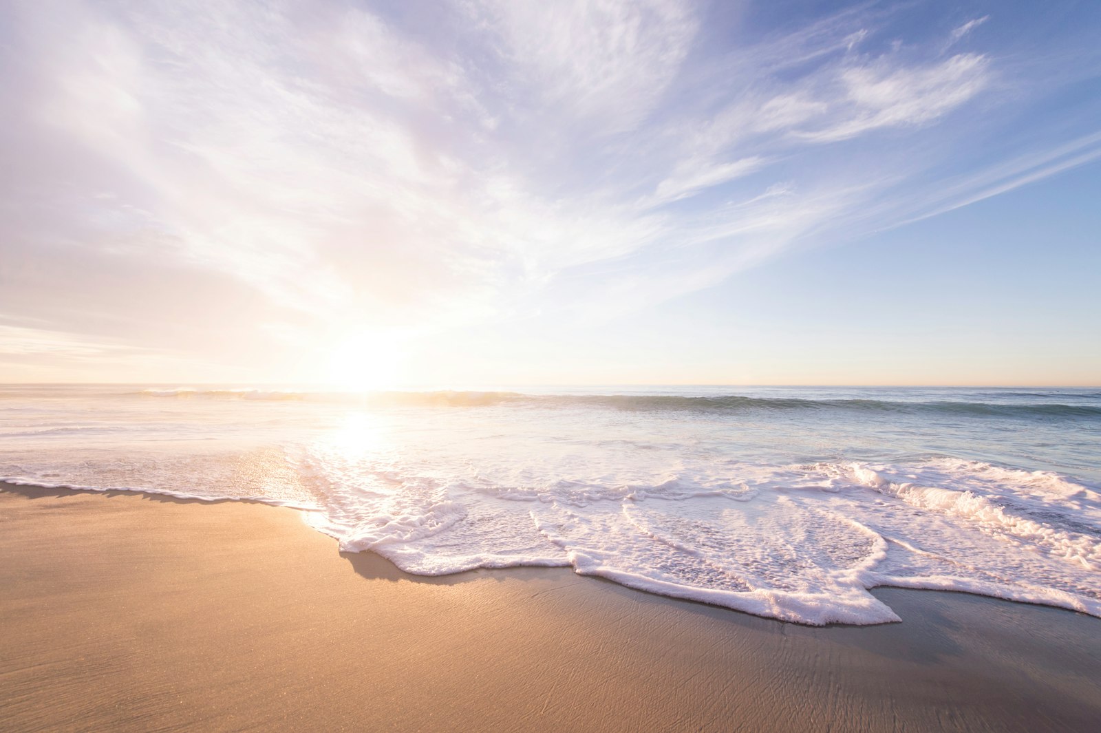 Surf washing over a long sandy beach